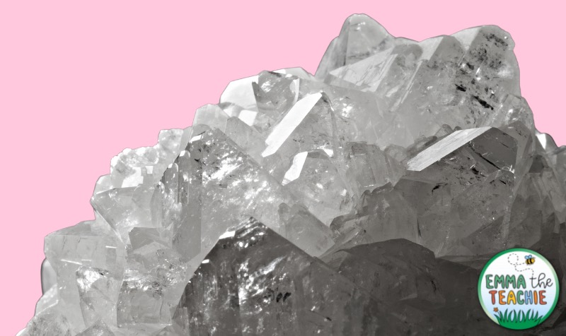 An image of white crystals against a pale pink background.