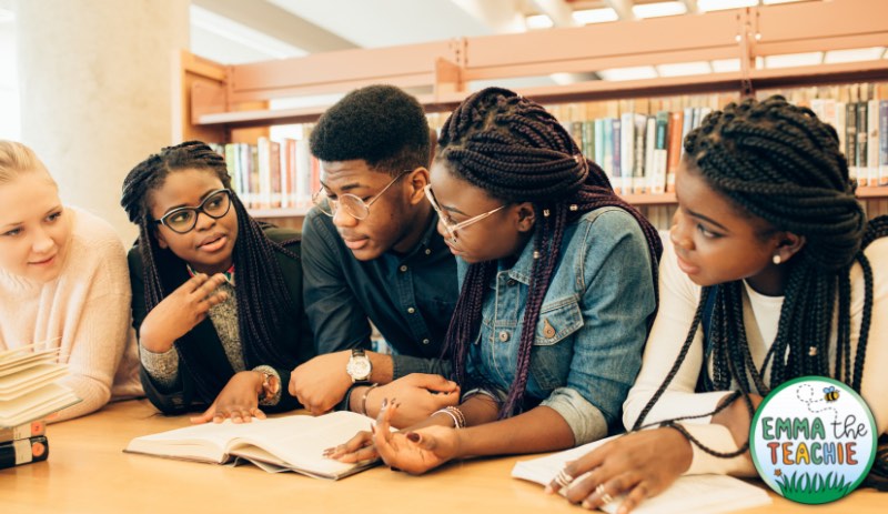 An image of a group of students working together in a library.