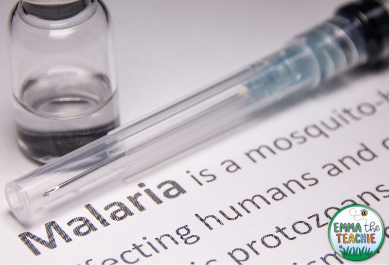 An image of a reading passage about malaria. There is also a shot and a vial of liquid next to the writing.