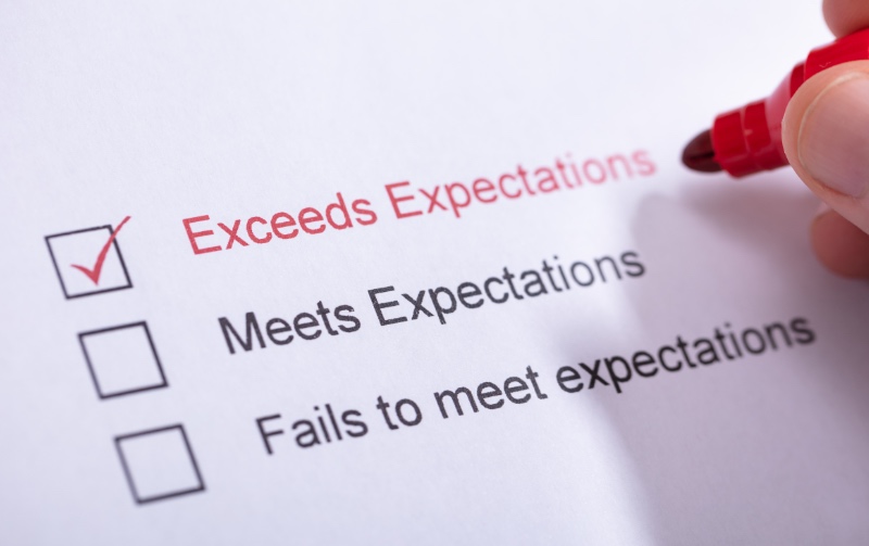 An image showing a checklist of expectations. There is a red pen marking, “Exceeds Expectations.” The other options are “Meets Expectations” and “Fails to Meet Expectations.”